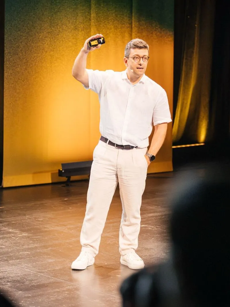 Hayder Schneider speaking on stage at Product at Heart, Hamburg