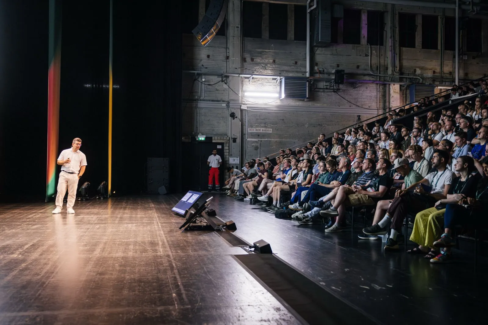 Hayder Schneider speaking to a packed auditorium at Product at Heart, Hamburg